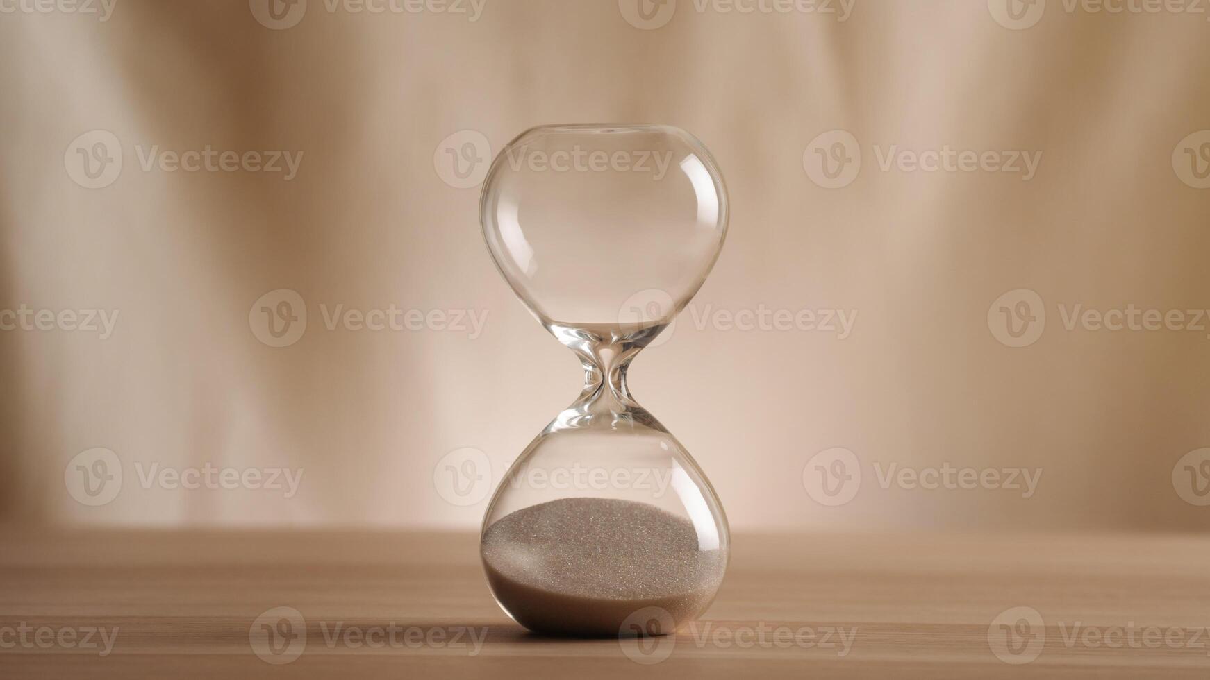 A simple hourglass on a wooden table with a beige backdrop, symbolizing time flow and minimalistic living. Represents timeless themes in a creative, uncluttered presentation for stylish concepts n photo
