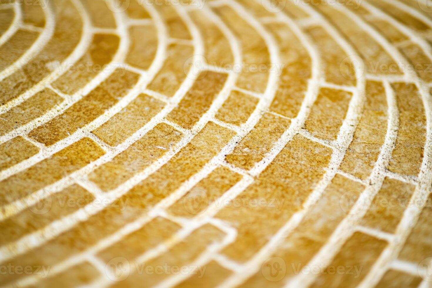 Warm circular stone pattern creating a textured surface photo