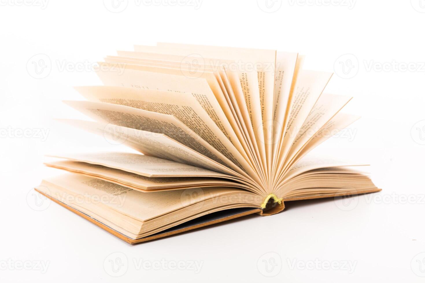 Open book with pages fanned out displaying text on a white background photo
