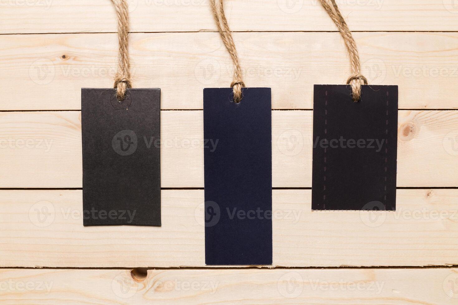 Handmade tags on string displayed on a wooden surface for craft projects and labeling photo