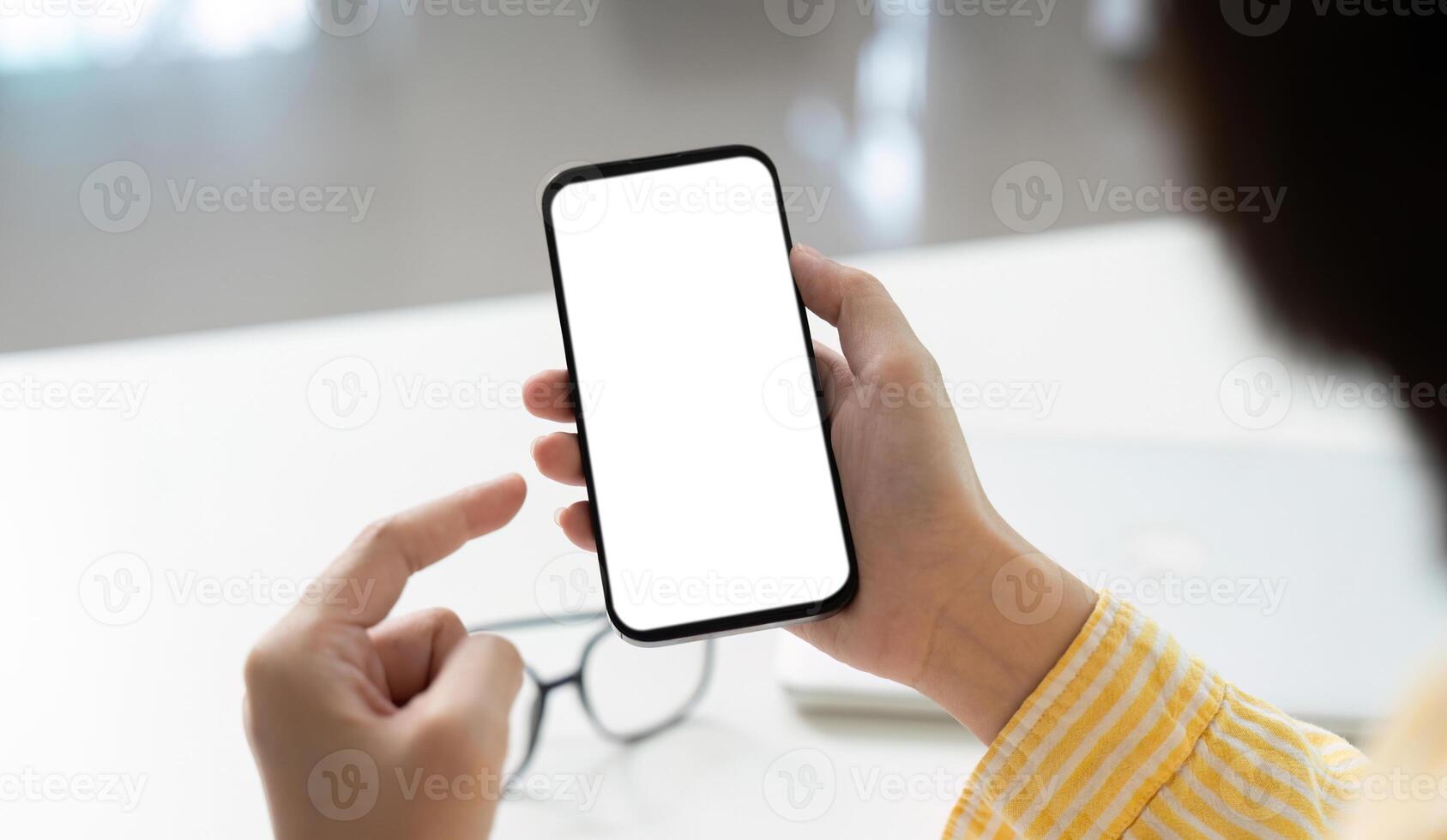 Mobile Technology. Individual interacting with smartphone displaying empty screen for app showcase. photo
