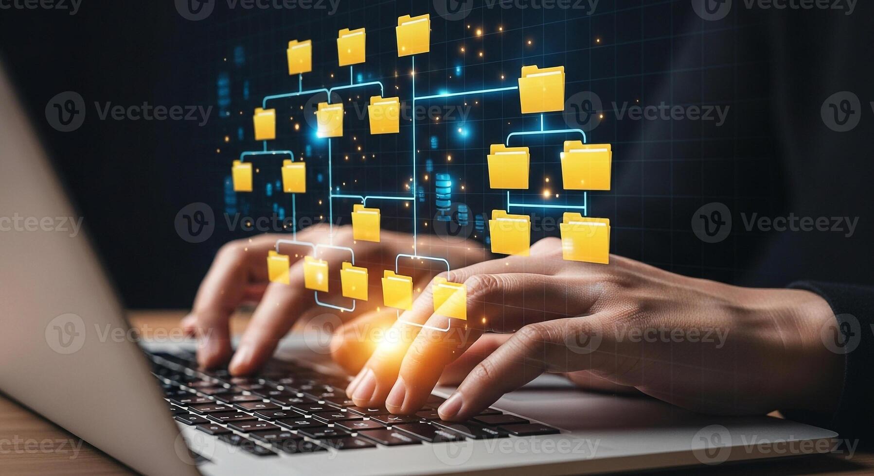 Person working on laptop computer managing digital files and data in a dark modern office showcasing efficient data organization and digital workflow photo
