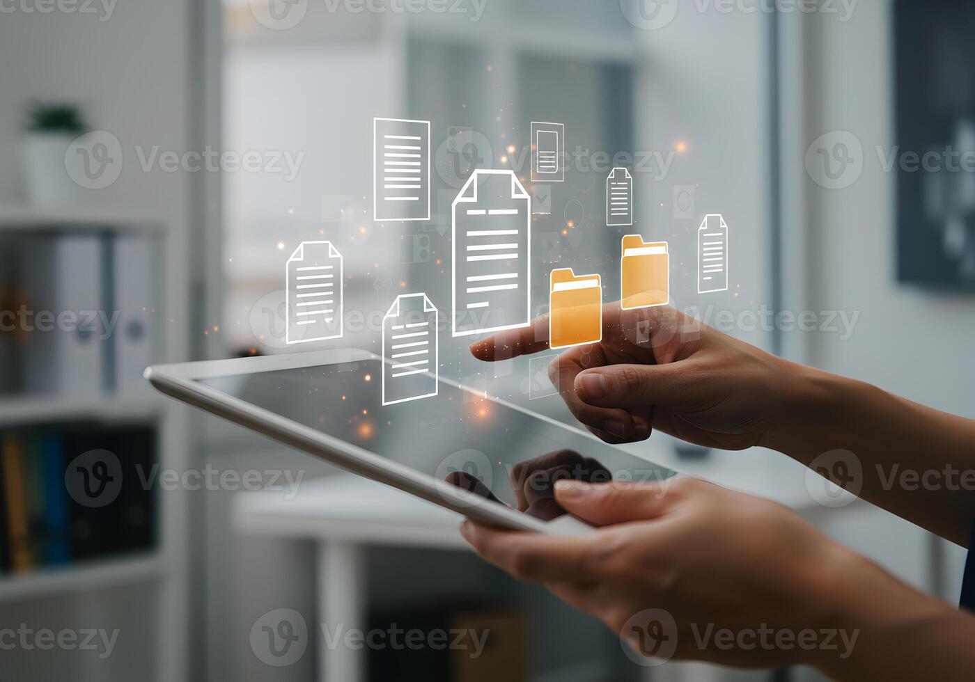 Person using a digital tablet to manage and organize digital documents and files in a modern office showcasing efficient workflow and seamless data management photo