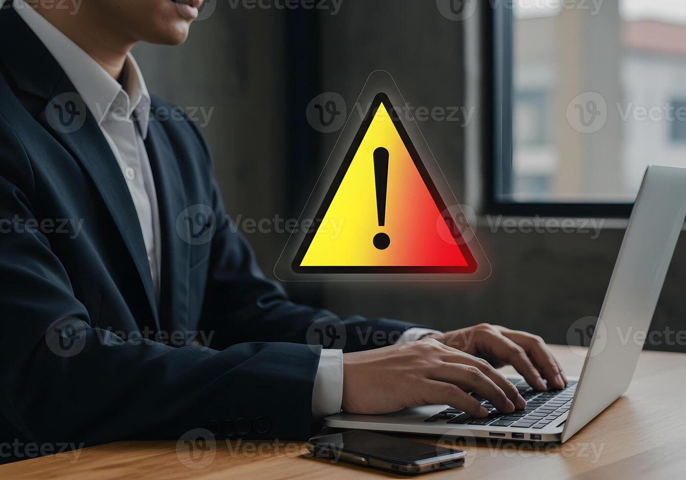 Businessman working on laptop with warning alert sign experiencing a problem or system error at his modern office desk Cybersecurity data breach and online threat concept image photo