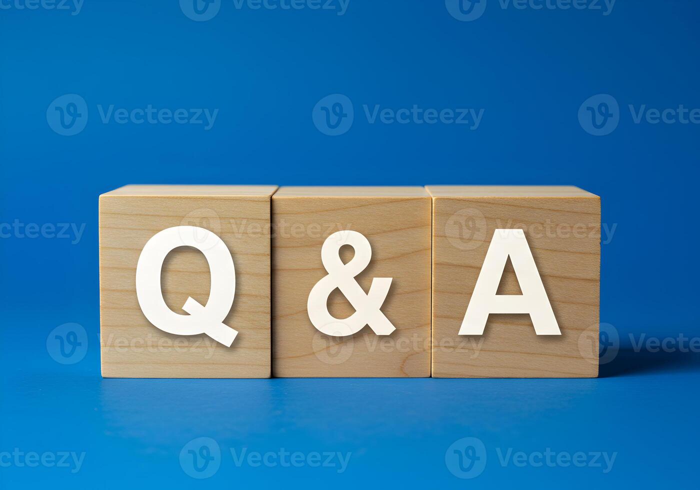 Wooden Blocks Spelling QA on Blue Background Questions and Answers Concept for FAQ Support and Help Desk photo