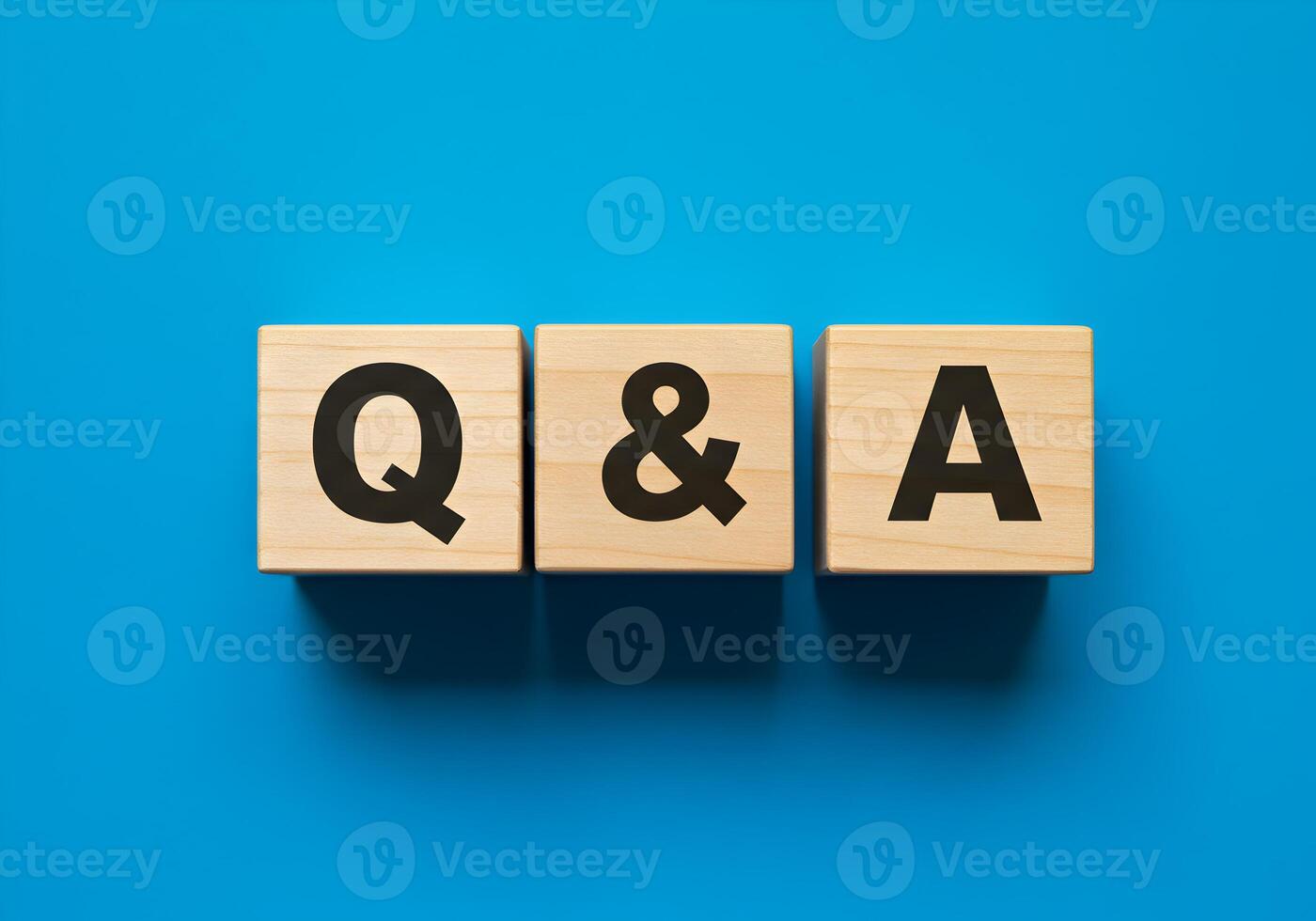 Wooden Blocks Spelling QA on a Blue Background Questions and Answers Concept for FAQ Support photo