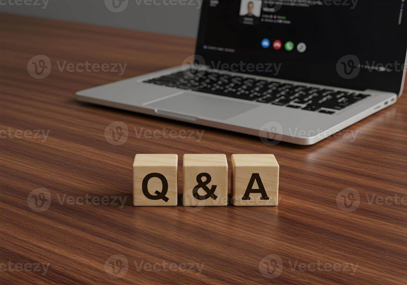 Wooden Blocks Spelling QA on Desk with Laptop Showing Online Meeting in Background - Questions Answers and Online Communication Concept photo