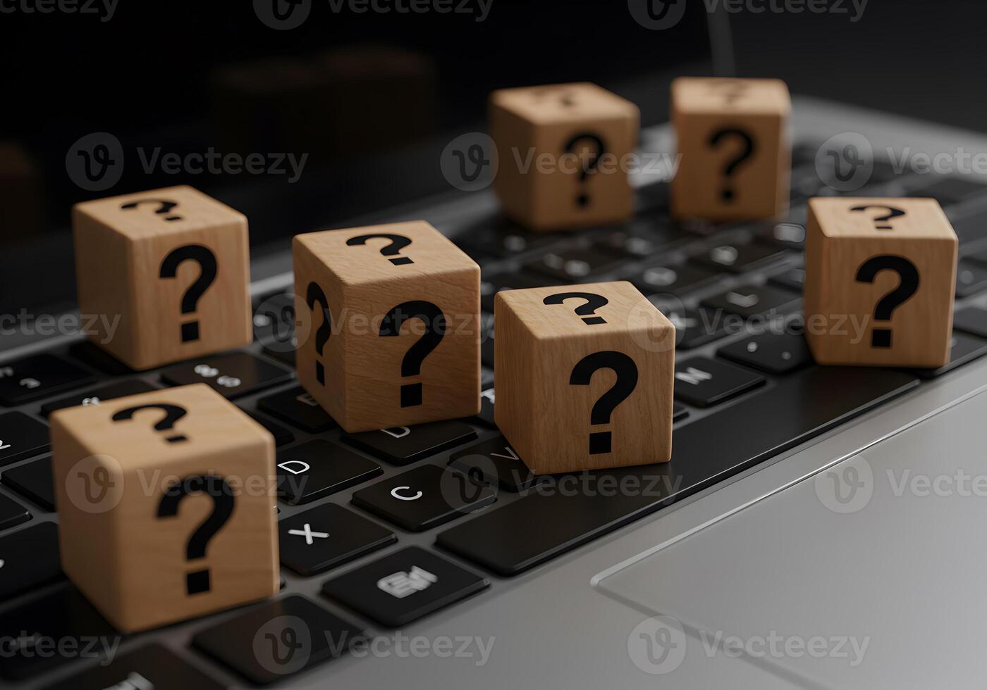 Wooden cubes with question marks on laptop keyboard uncertainty questions doubts problems issues challenges digital online technology internet computer search solution answer faq help support faq trou photo