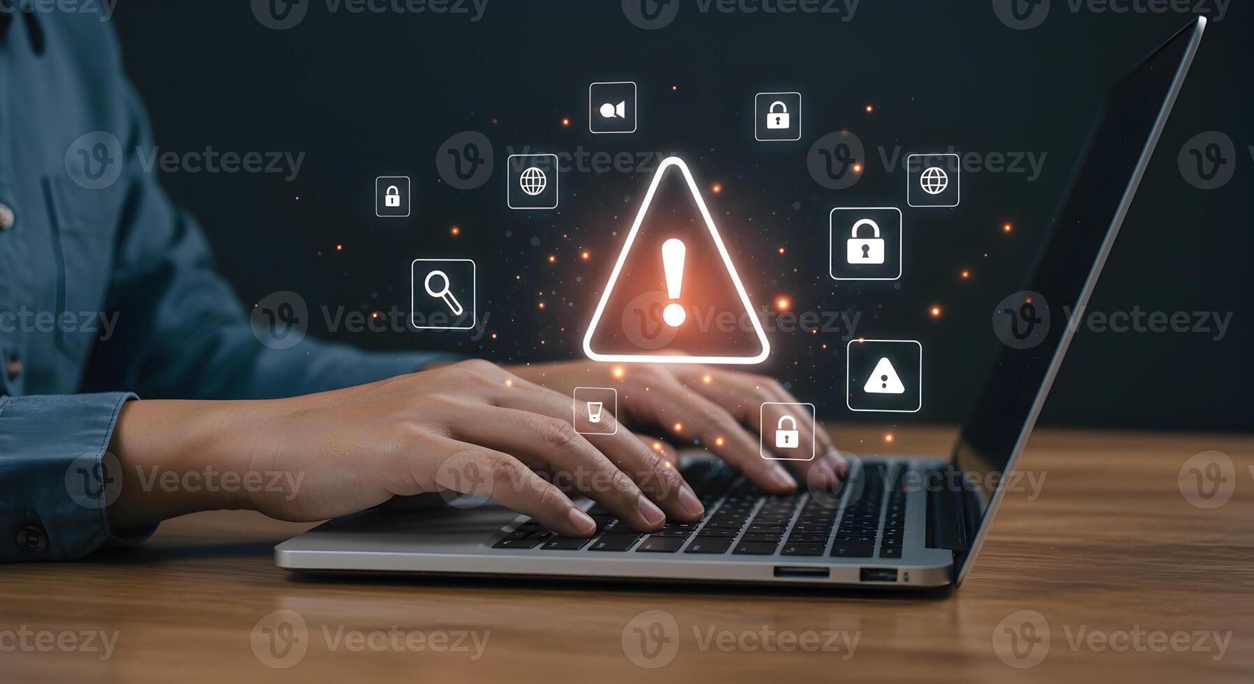 Person working on laptop computer with digital security alert warning notification icons cybersecurity data breach privacy risk management concept image photo
