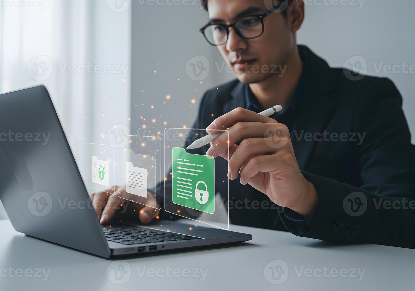 Businessman using stylus pen to manage digital files secured with a padlock icon on a laptop screen in a modern office signifying secure data management and digital privacy photo