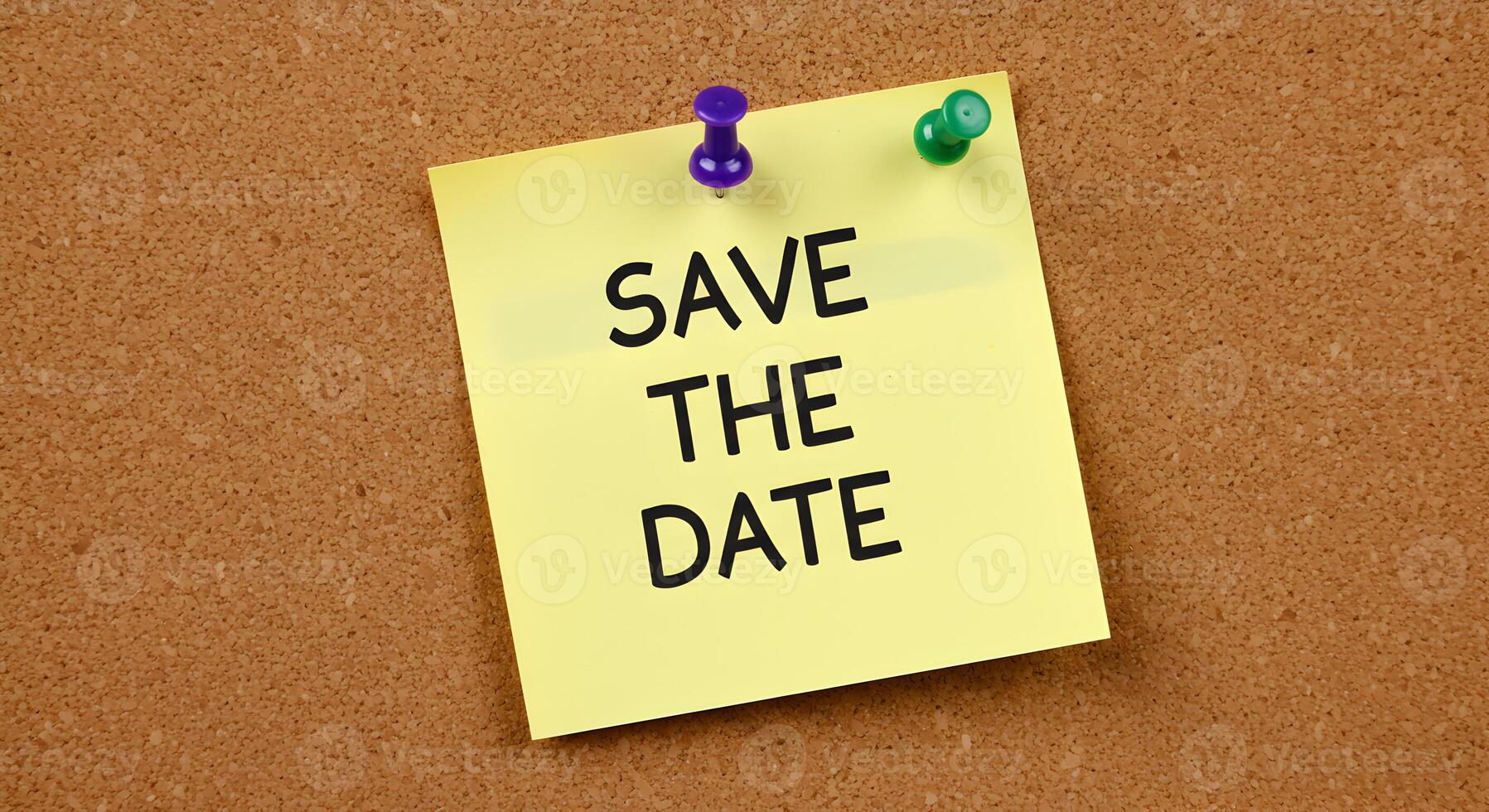 Yellow sticky note pinned to a cork board with the text Save The Date signifying an upcoming event or reminder This image evokes feelings of anticipation and planning Ideal for event planning reminder photo