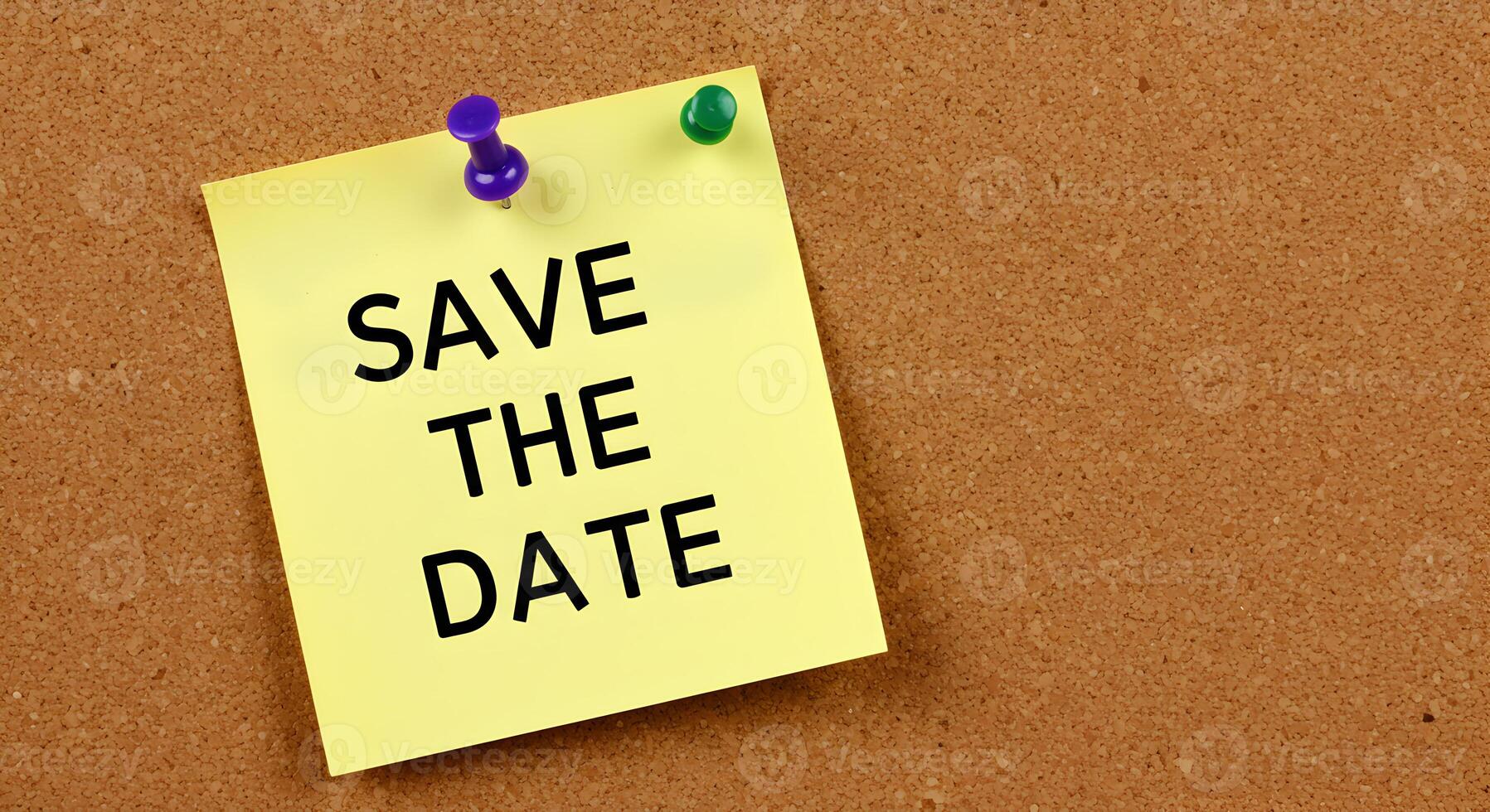 Yellow sticky note pinned to a corkboard with the text Save The Date written in bold black letters a reminder message for an important event or occasion photo