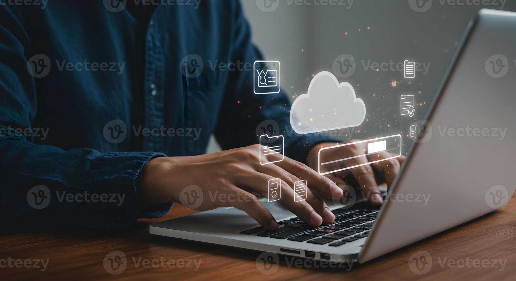 Person working on laptop computer accessing cloud data and digital files in a modern home office setting showcasing the concept of remote work and digital storage photo