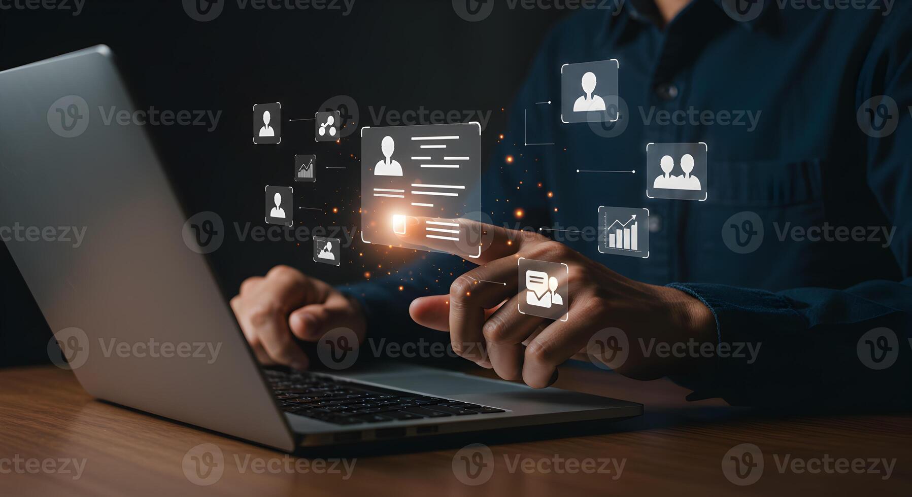 Man using laptop computer to manage digital profiles and data networking and analyzing information illuminated in a dark modern office setting The image evokes a concept of digital business and modern photo