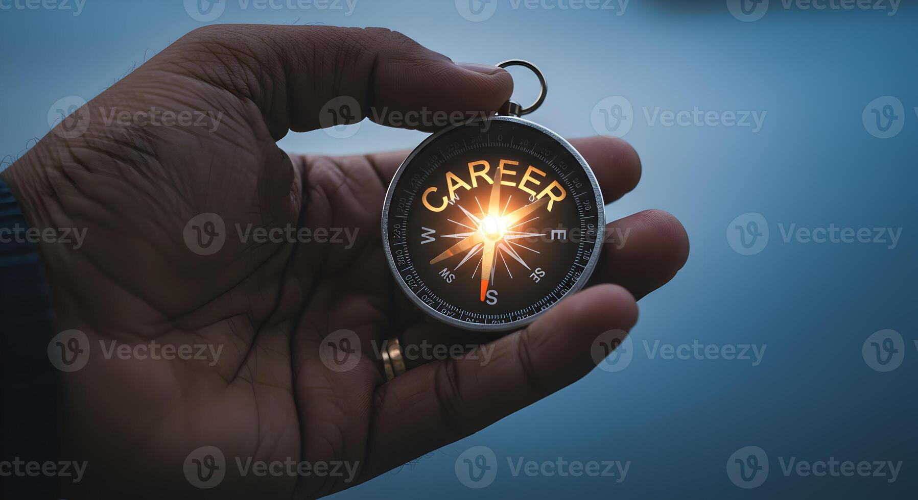 Hand holding compass with glowing CAREER word symbolizing career path direction guidance and future planning The image evokes feelings of ambition motivation and the journey towards professional succe photo