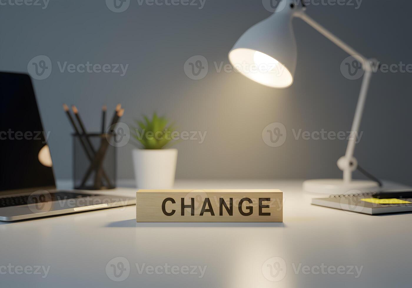 Wooden block with the word CHANGE on a modern office desk illuminated by a desk lamp signifying transformation and new beginnings photo