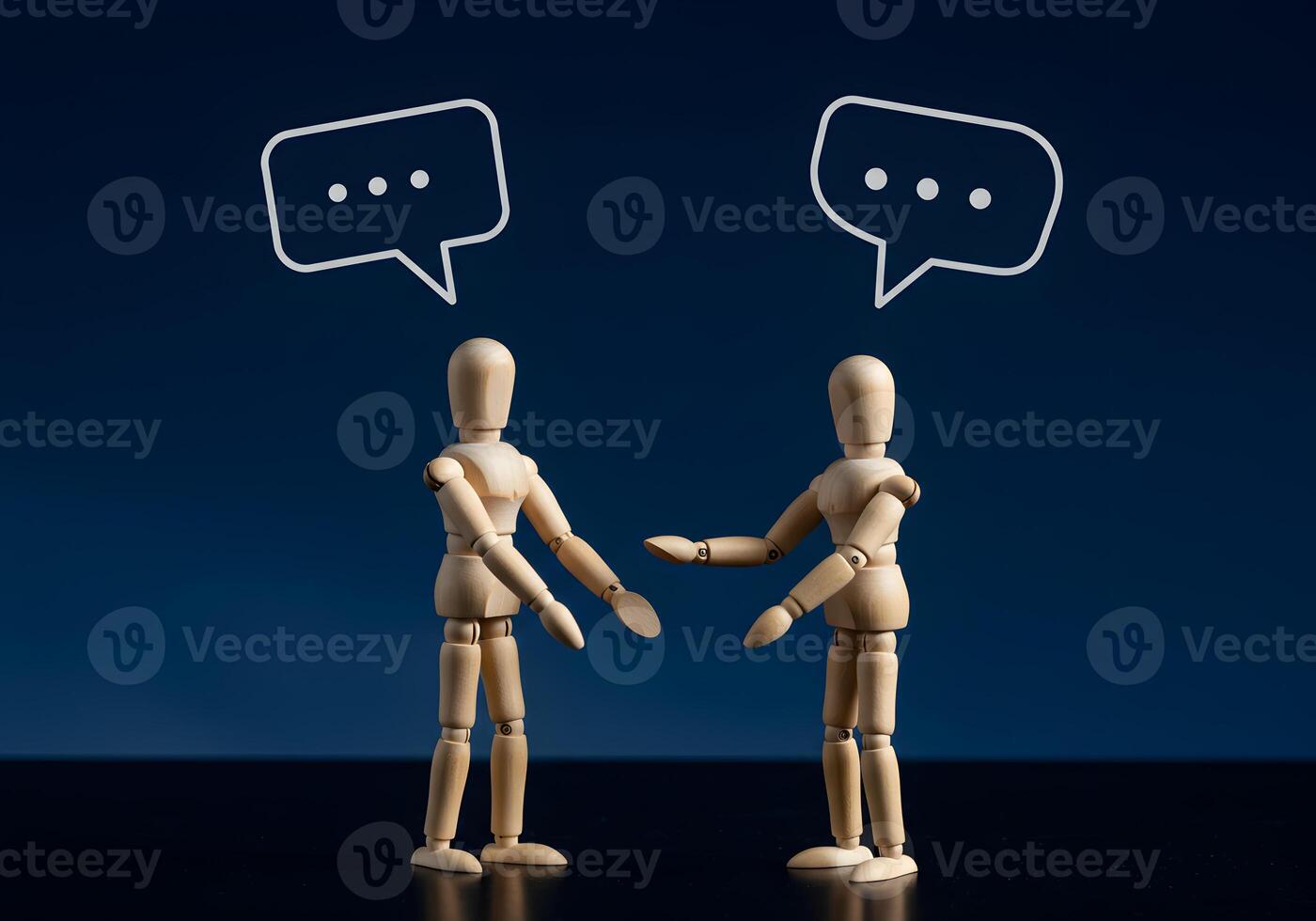 Wooden Mannequins Communicating Against a Dark Blue Background Representing Conceptual Dialogue and Interaction in a Studio Setting The image evokes a sense of communication conversation and connectio photo