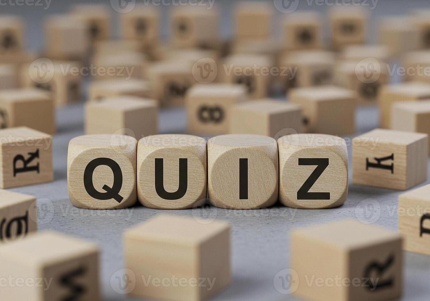 Quiz concept with wooden cubes on a table spelling out QUIZ surrounded by other letter blocks The image evokes a sense of testing assessment and knowledge Ideal for educational or business contexts re photo
