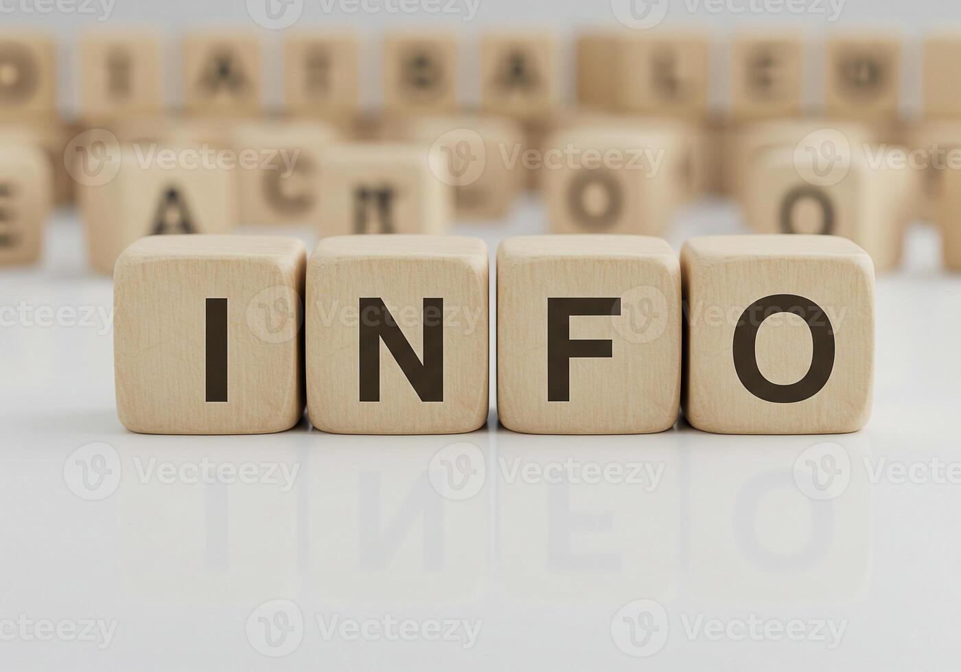 Wooden cubes spelling INFO on bright surface with blurred alphabet blocks in background conveying data information and knowledge concept photo