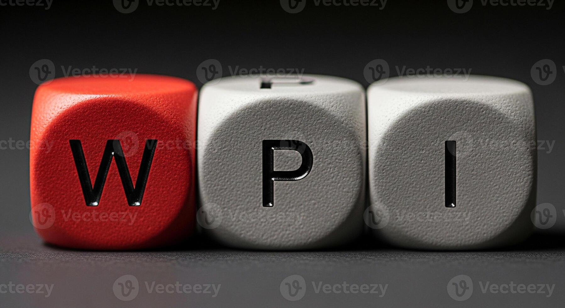 Three dice spelling out wpi on a dark surface in a macro studio shot close up view photo