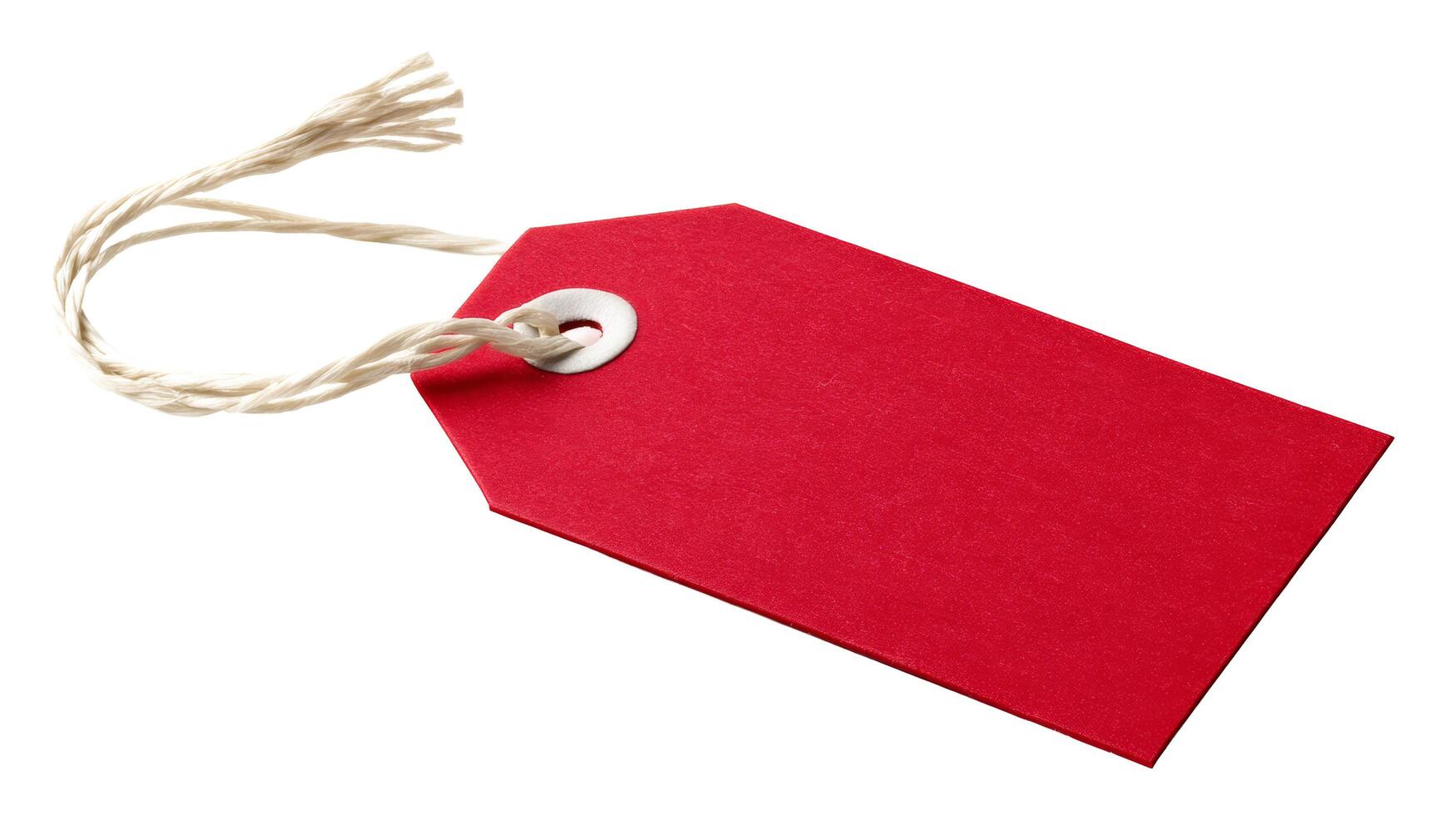 A solitary red tag with string attached, isolated against a plain white background, angled slightly right photo