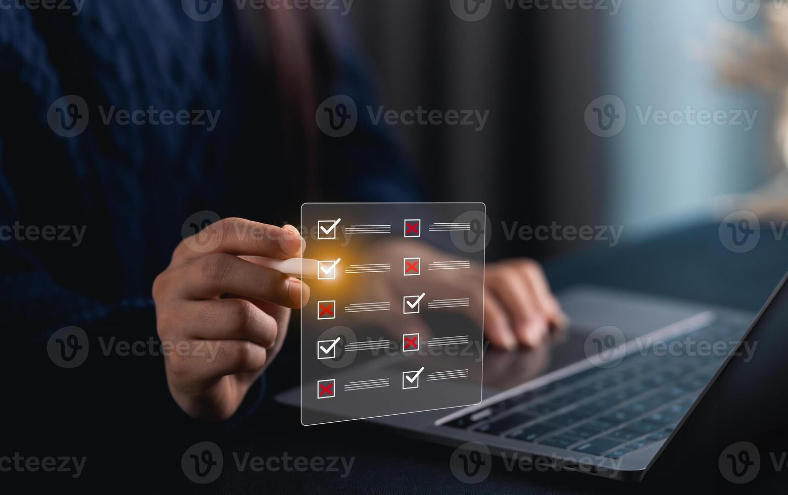 Close-up hand woman using digital checklist on laptop while managing tasks and projects for effective organization in modern workspace with ambient light photo