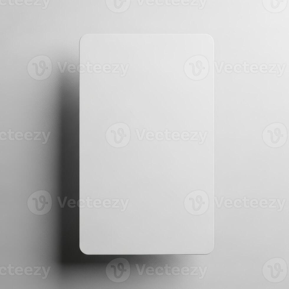 A blank white rectangular card casting a subtle shadow isolated on white background photo