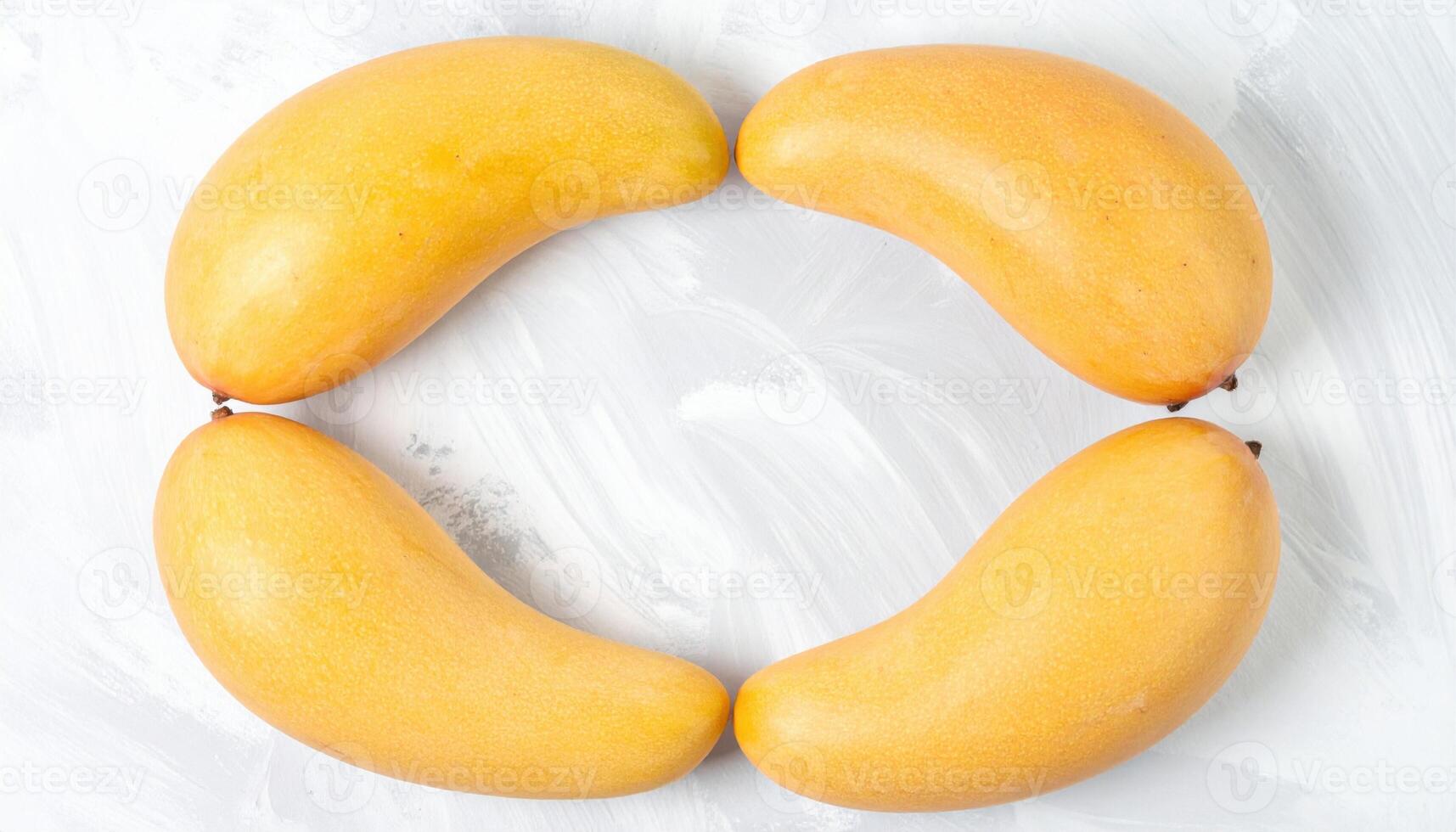 Mango stone husks cleaned and aligned as sculptural ovals on chalk backdrop with faint texture refined botanical still life for editorial and design photo