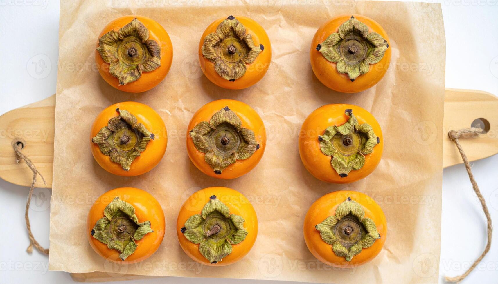 Persimmon calyx portraits arranged in a tidy grid on warm parchment botanical minimal for editorial education packaging and typography friendly brand layouts photo