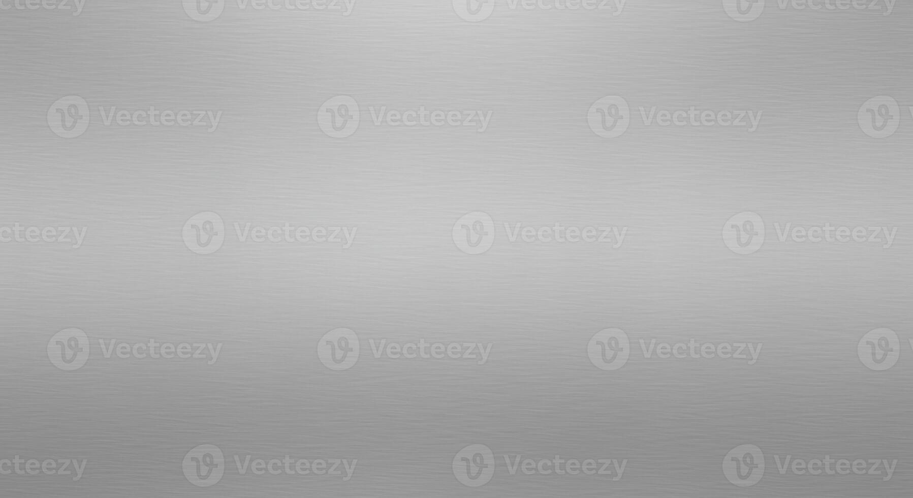 A subtly textured silver background showcases a smooth gradient from light to dark, creating a versatile surface for various design applications and overlays. photo