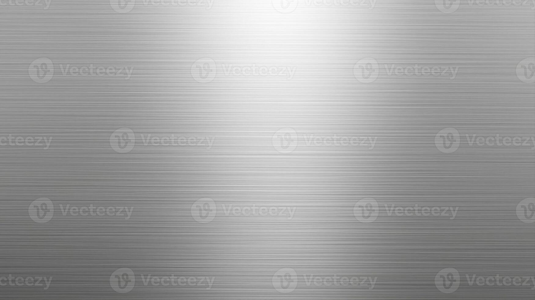 The brushed metal surface shows a subtle gradient of light from bright highlights to darker shadows, creating a sleek and modern industrial design element here. photo