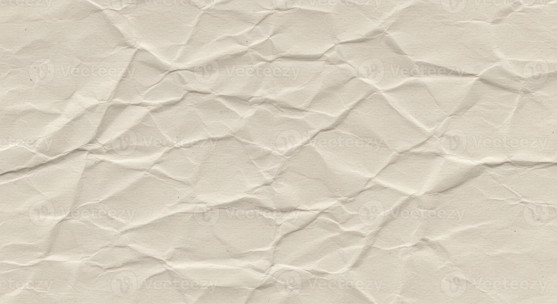 The texture of a slightly crumpled sheet of light beige paper creates an interesting abstract pattern perfect for backgrounds or adding visual interest to designs. photo