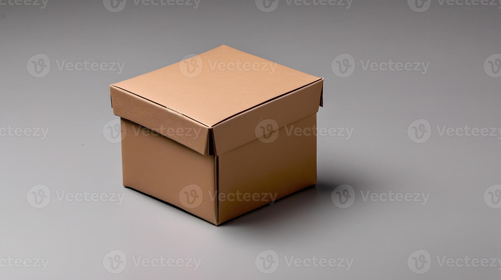 A small cardboard box with its lid partially askew sits on a gray surface, casting a soft shadow behind it. photo
