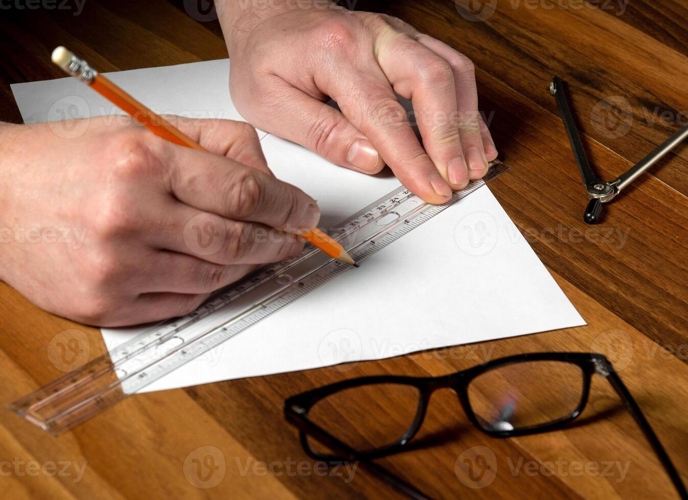 Closeup of man hands holding pencil and ruler. Working environment on the office table before creating plan for or project photo