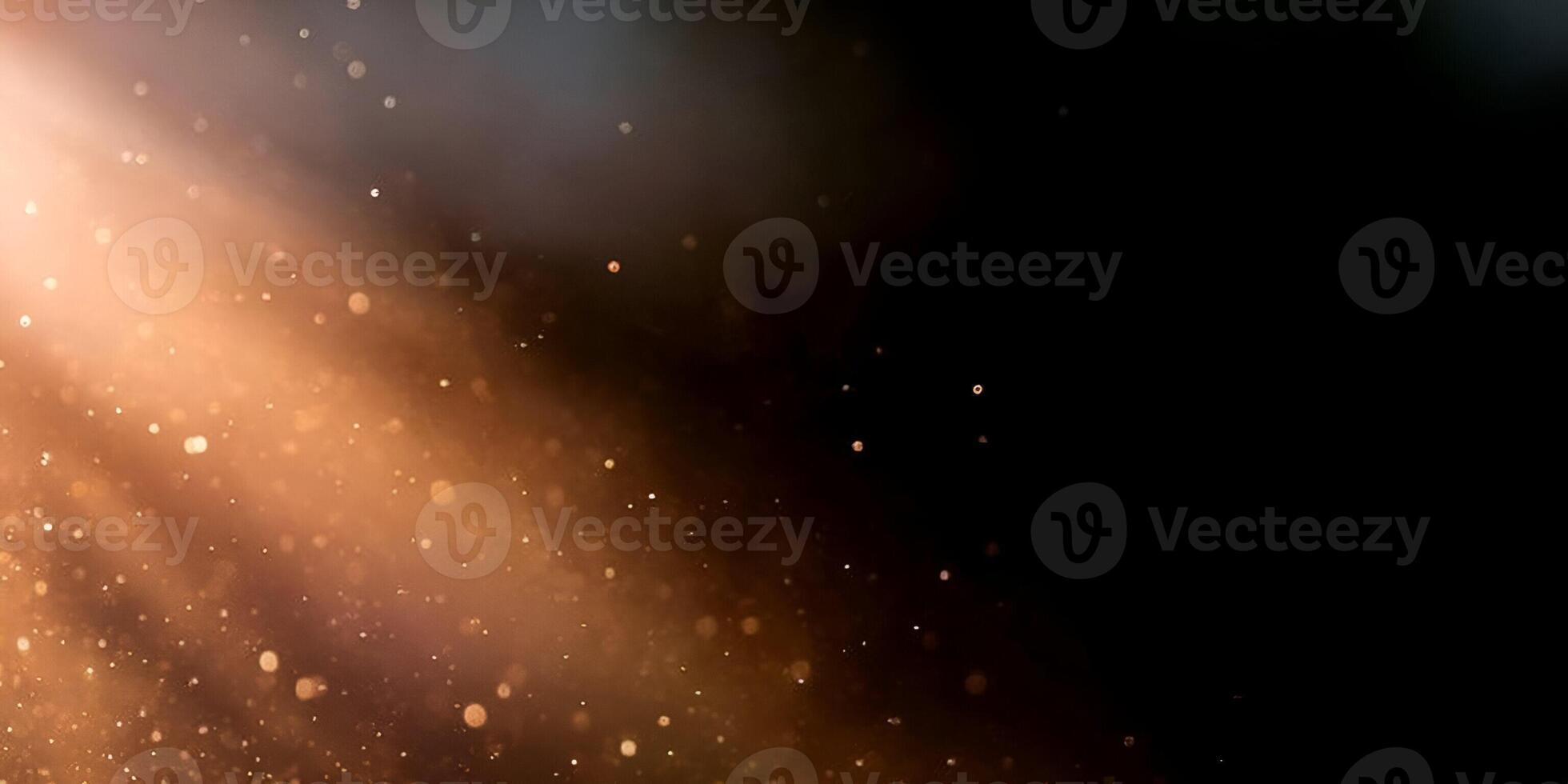 Golden light rays illuminate dust particles creating a beautiful atmospheric bokeh effect on a dark background photo