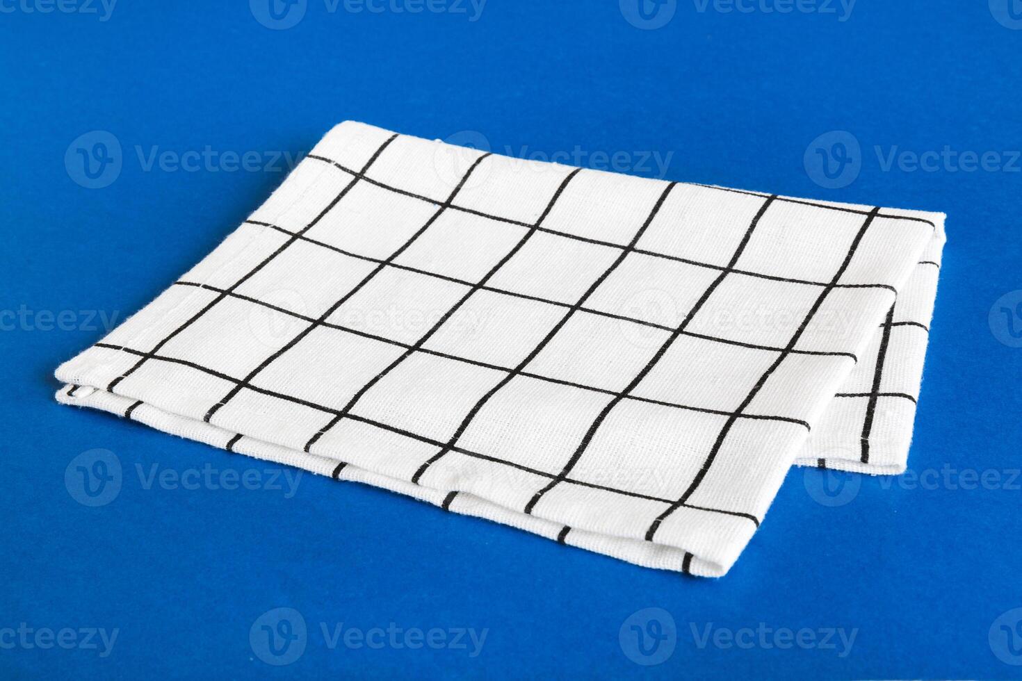 top view with white empty kitchen napkin isolated on table background. Folded cloth for mockup with copy space,Minimal style photo