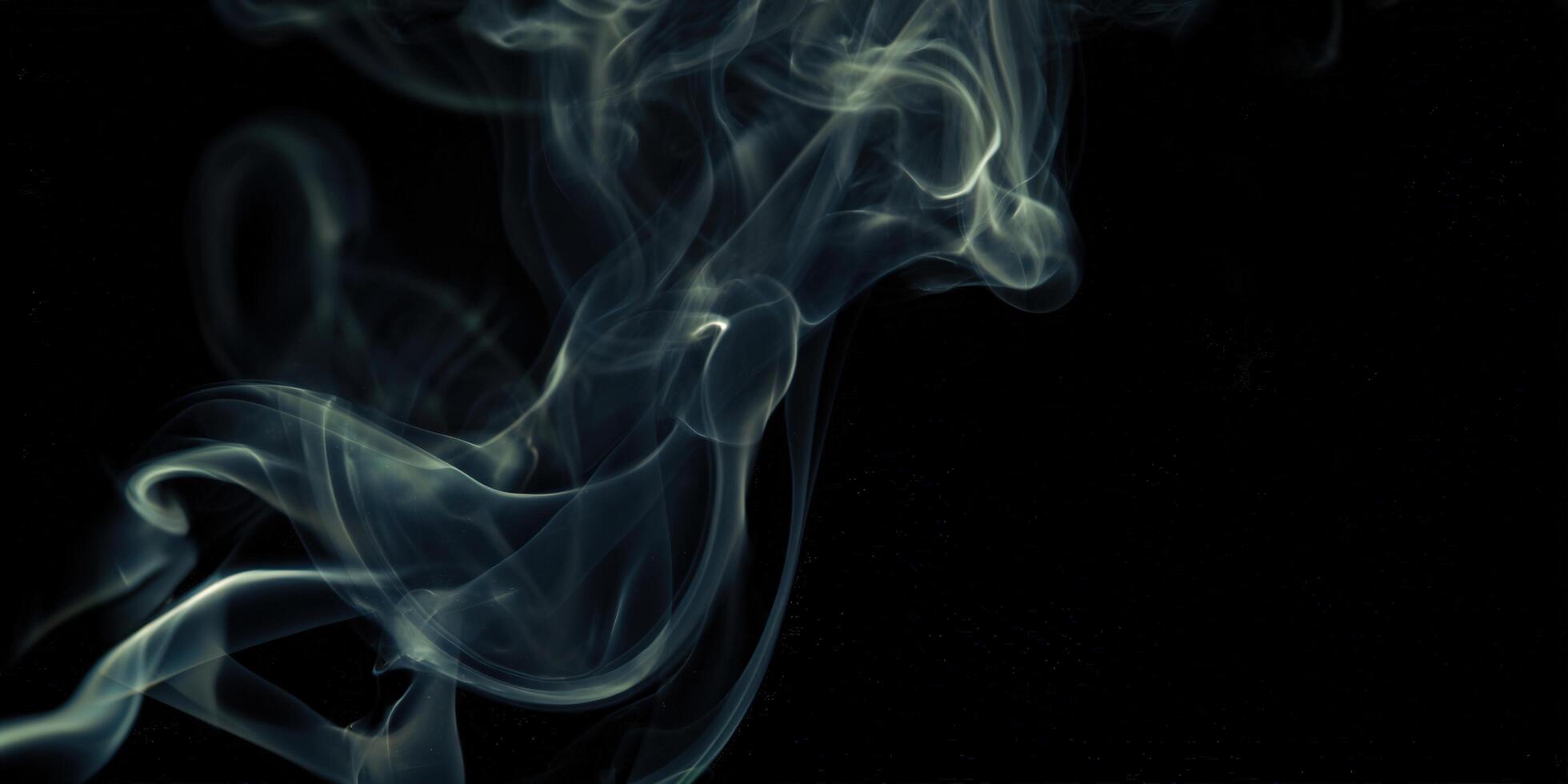 Abstract smoke gracefully dances against a deep black background, creating an enchanting visual. photo