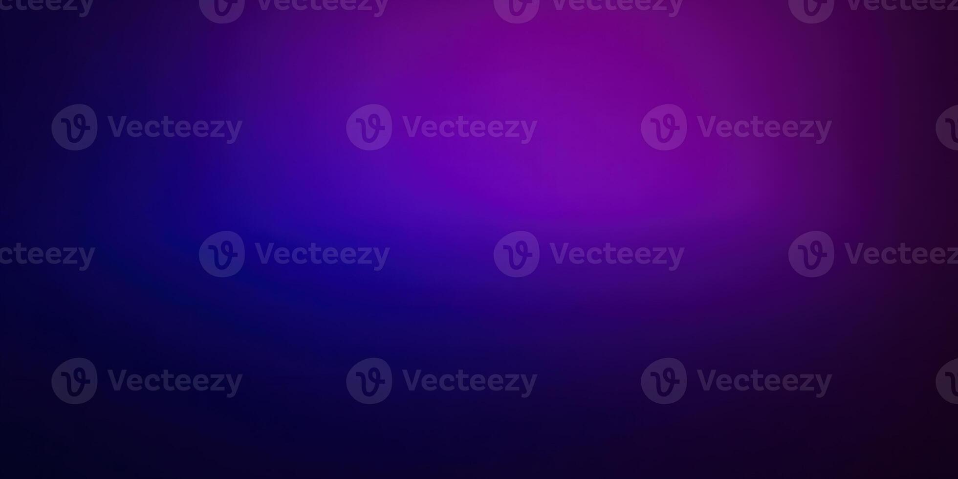 A captivating gradient of purple and blue forms a dynamic and abstract background. photo