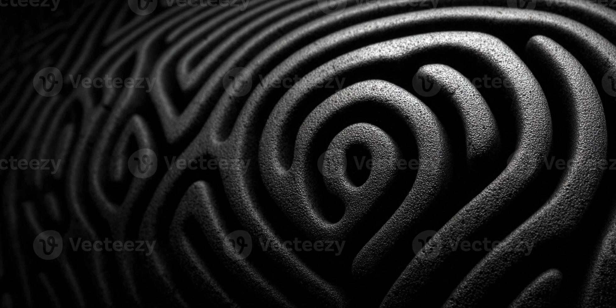 A black and white image of a complex maze pattern on a textured surface photo
