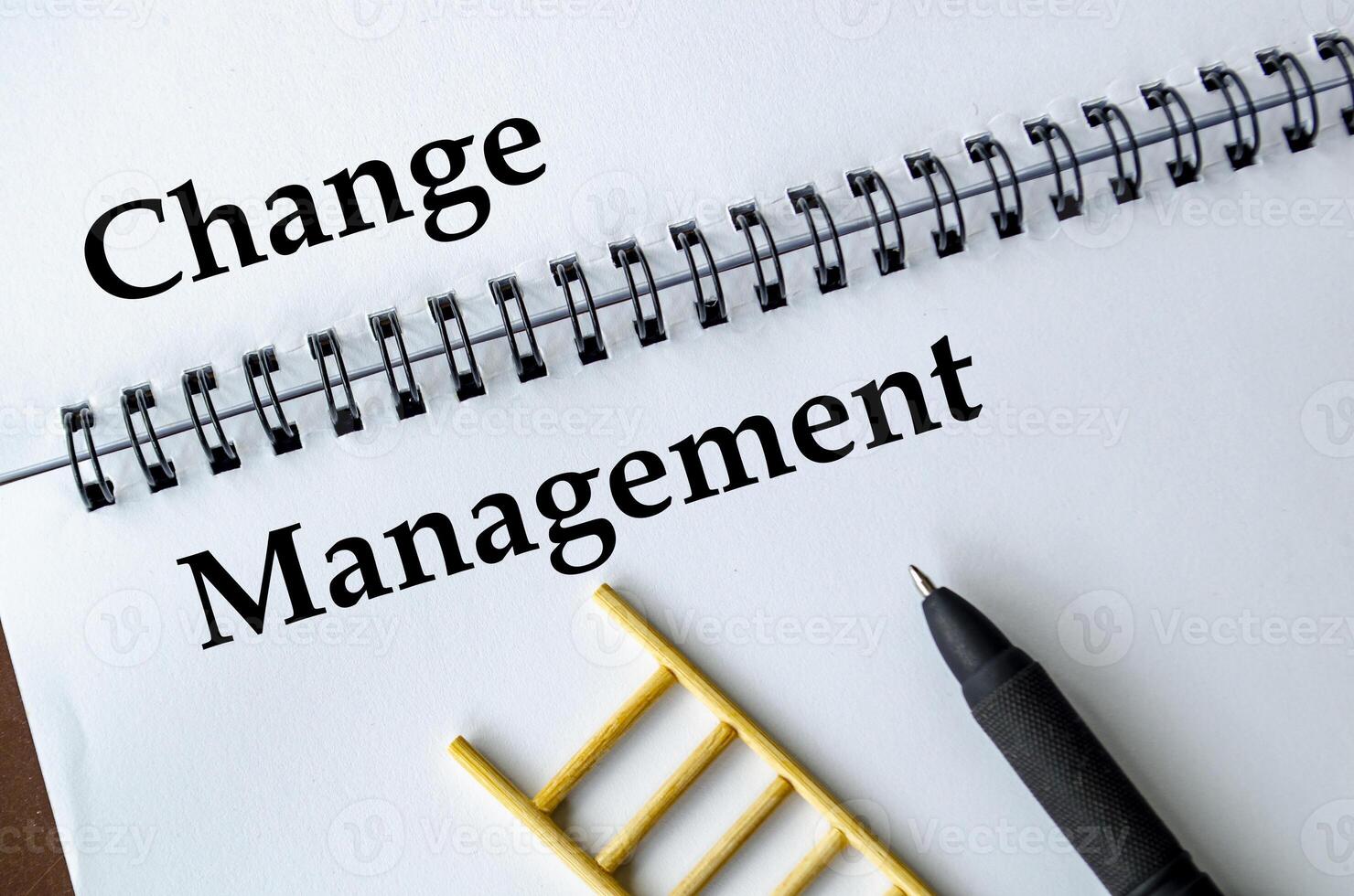 Change Management, Notebook with ladder illustration symbolizing adaptation, transition, and transformation. photo