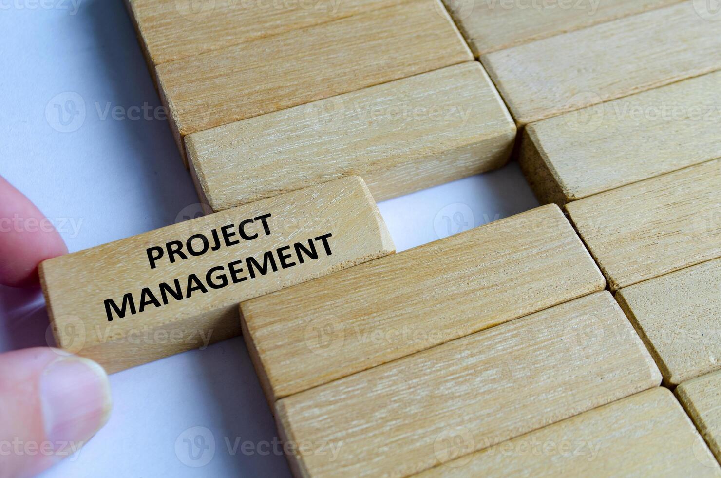 A wooden block engraved PROJECT MANAGEMENT placed on steps symbolizing execution, organization, planning, goals and delivery. photo