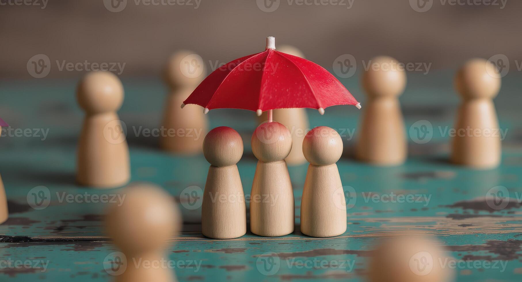 Wooden figures under a red umbrella symbolizing protection and security on a textured surface setting scene photo