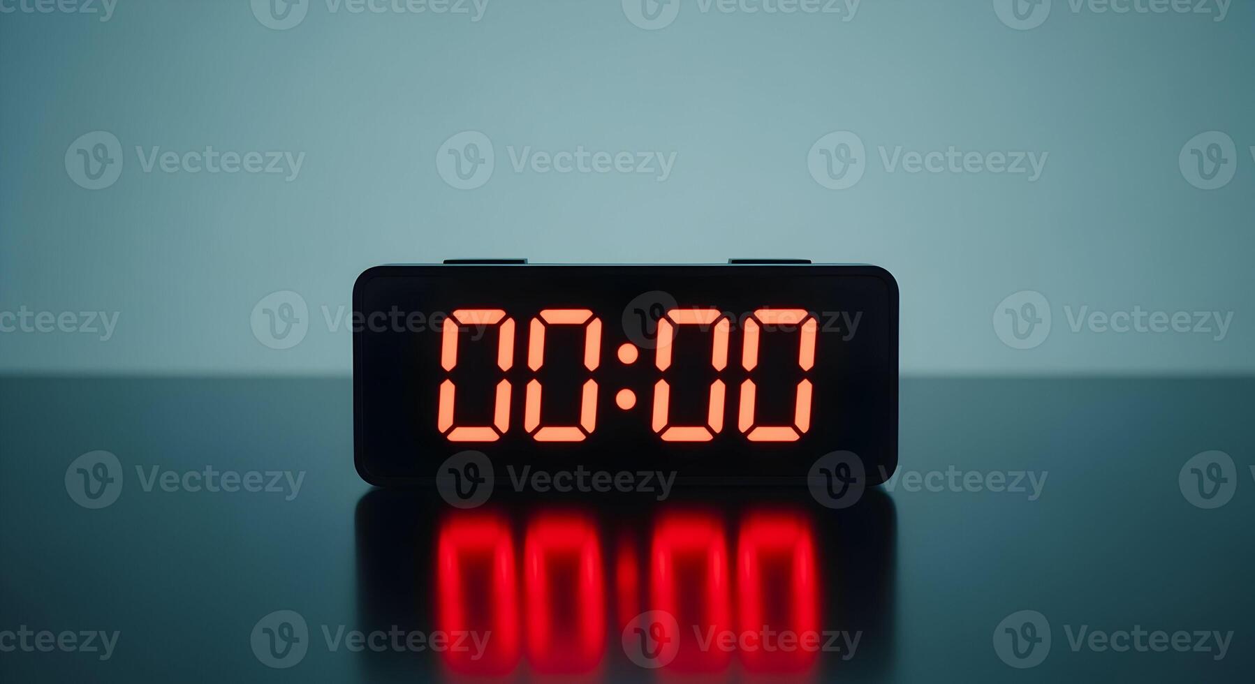 Observe the digital clock displaying midnight with its bright red glowing numbers clearly shown photo