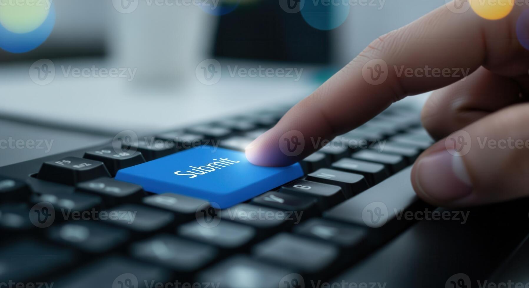 Close up of a finger pressing a glowing blue submit button on a black computer keyboard photo
