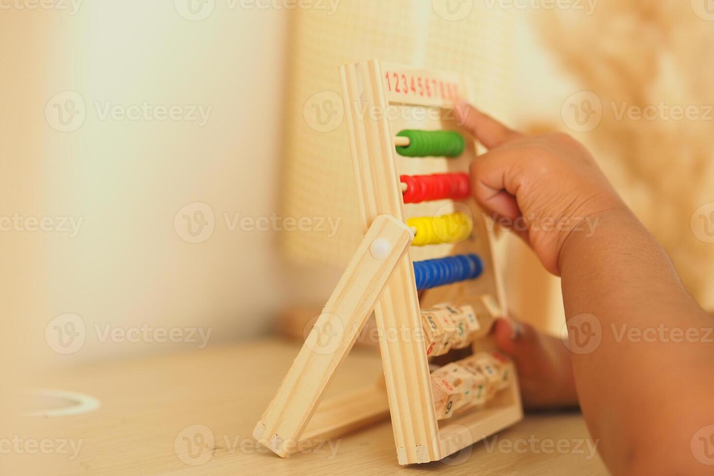 Child learns numbers with colorful counting frame in home photo