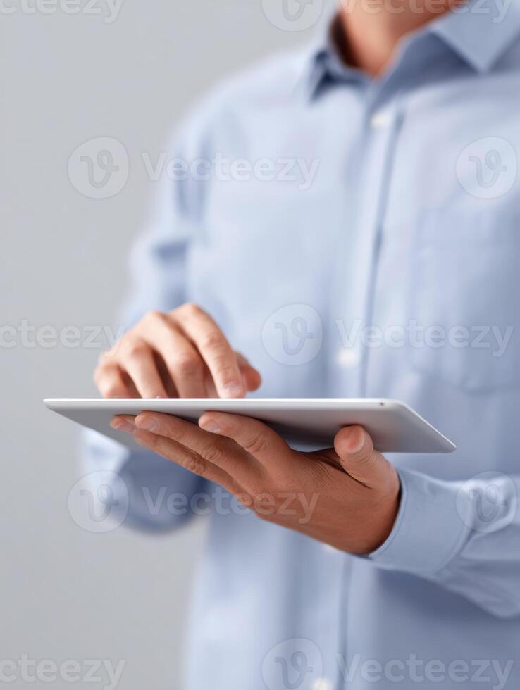 Focused businessman using digital tablet for corporate work. professional manager is approving workflow with modern technology, feeling efficient and productive photo