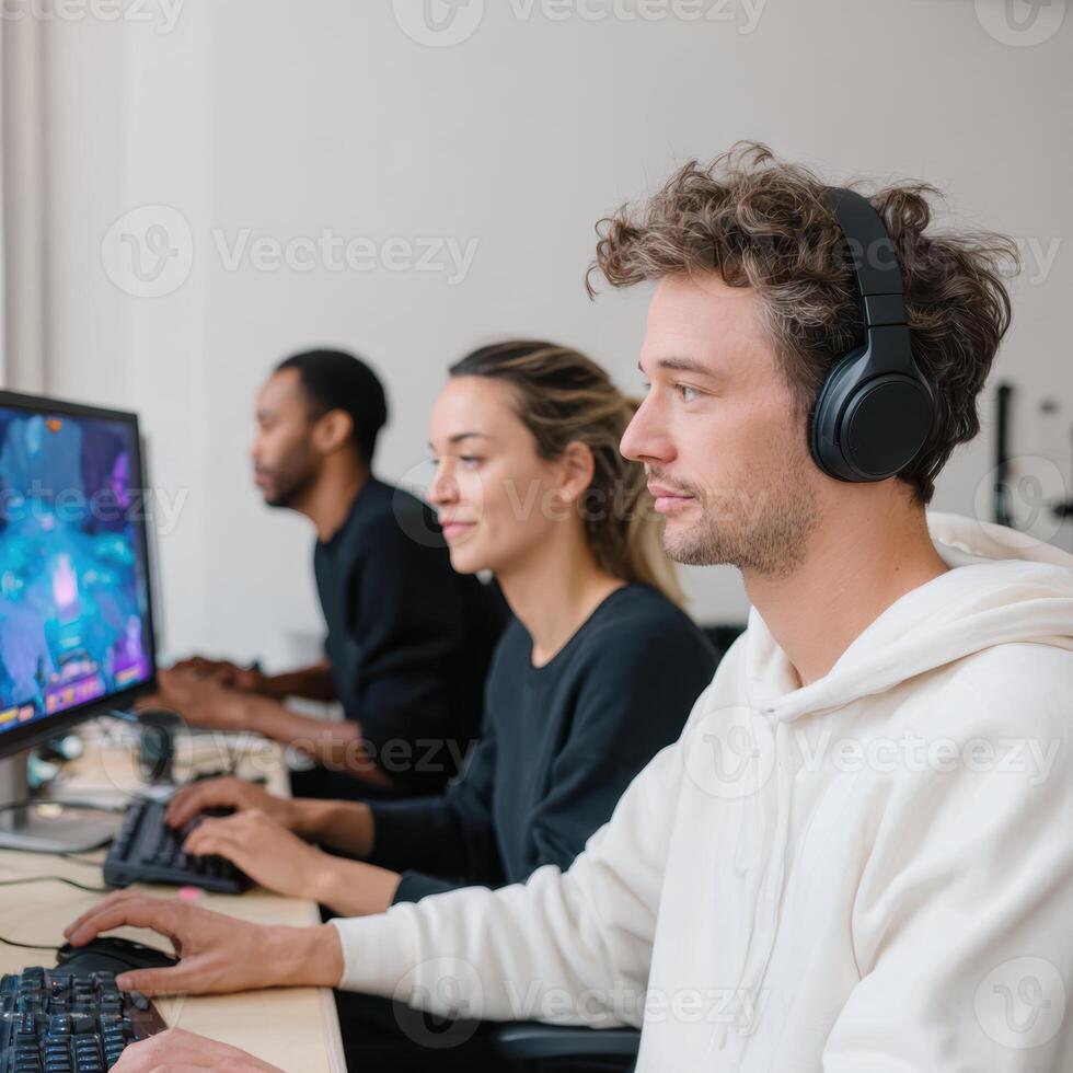 Focused team of game developer colleagues testing new game. Software development in modern office using technology for programming with intense concentration photo
