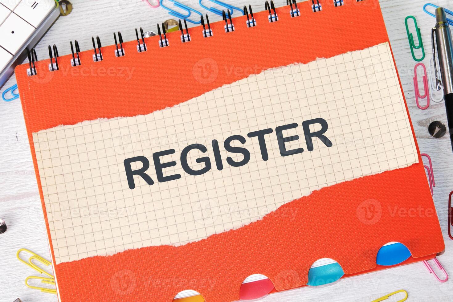 Conceptual register symbol. Copy space. Register written on a piece of paper in a cage on the background of a notebook photo