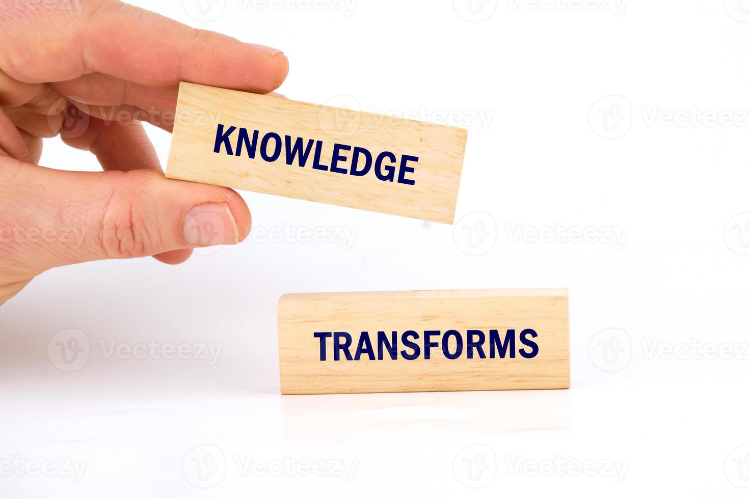 Knowledge learning innovation concept. KNOWLEDGE TRANSFORMS words made from blocks with hand on white background photo