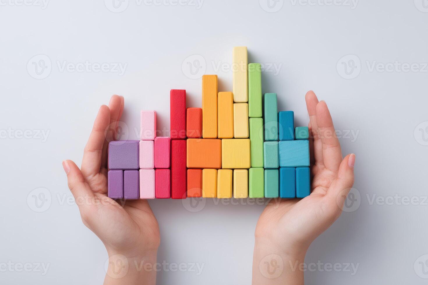Hands holding colorful blocks with a bar graph photo